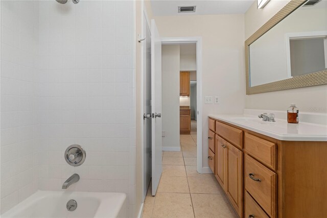 bathroom with washtub / shower combination, vanity, and tile patterned floors