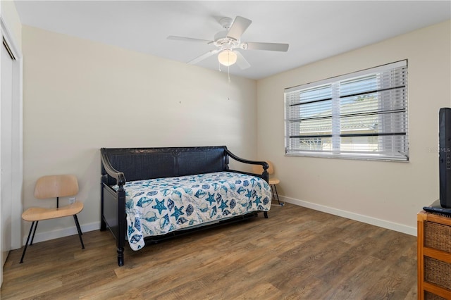 bedroom with ceiling fan and dark wood-type flooring