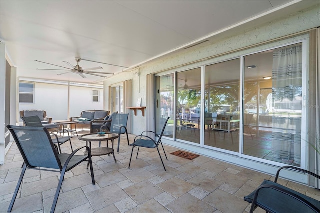 sunroom featuring ceiling fan