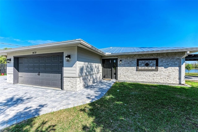 single story home featuring a front lawn and a garage