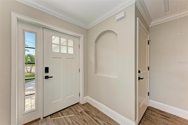 entrance foyer featuring hardwood / wood-style flooring and crown molding