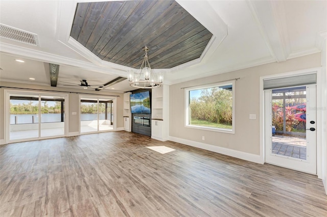 unfurnished living room with ornamental molding and plenty of natural light