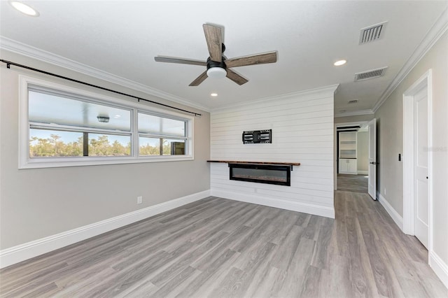 unfurnished living room featuring ornamental molding, ceiling fan, and light hardwood / wood-style flooring