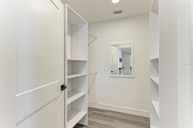 spacious closet featuring light hardwood / wood-style floors