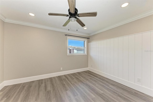 spare room with ornamental molding, ceiling fan, and light wood-type flooring