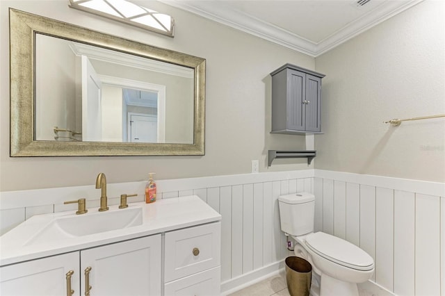 bathroom with toilet, vanity, and ornamental molding