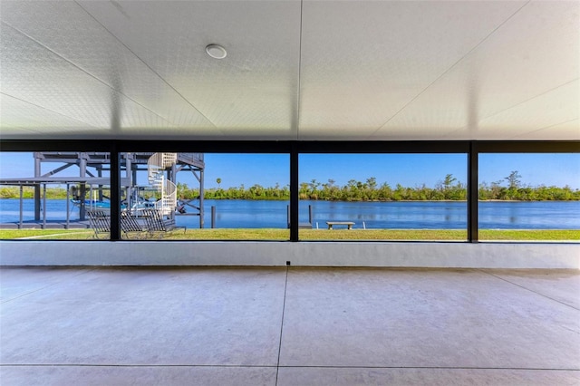 unfurnished sunroom with a water view