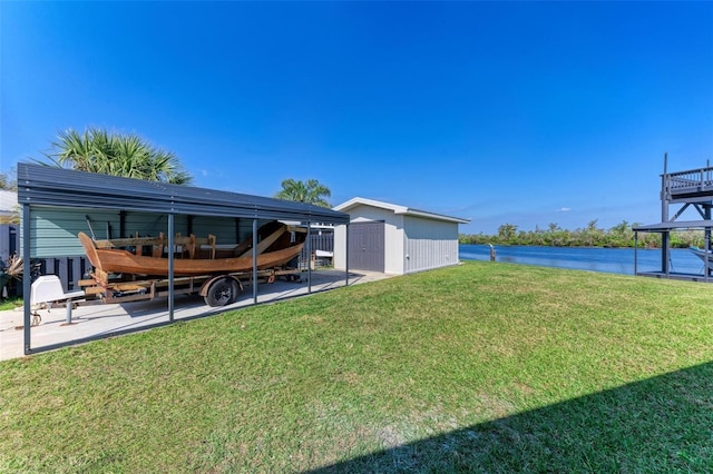 view of yard with a storage shed and a water view