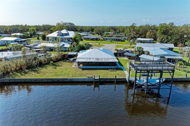 dock area featuring a lawn and a water view