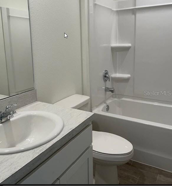 full bathroom with vanity, shower / bathing tub combination, and toilet