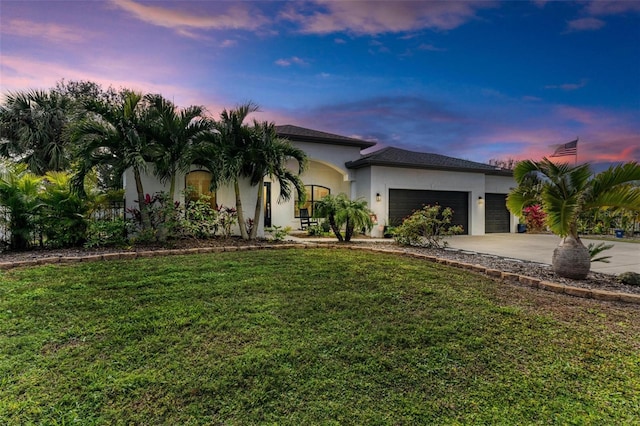 view of front facade with a garage and a lawn