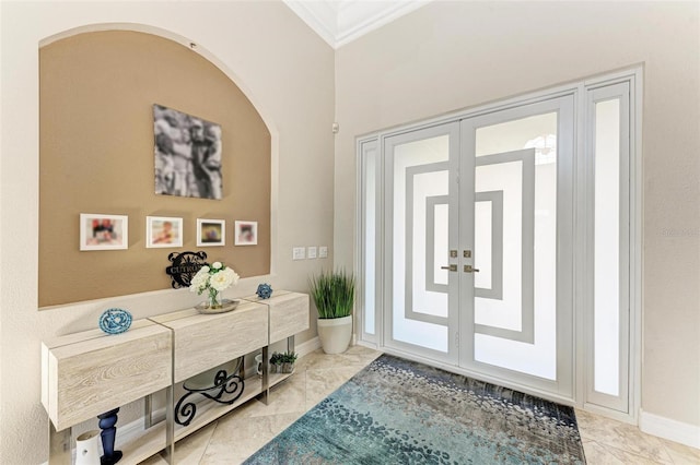 foyer entrance with crown molding and french doors