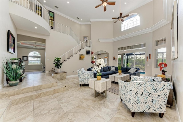 living room featuring a towering ceiling and ornamental molding