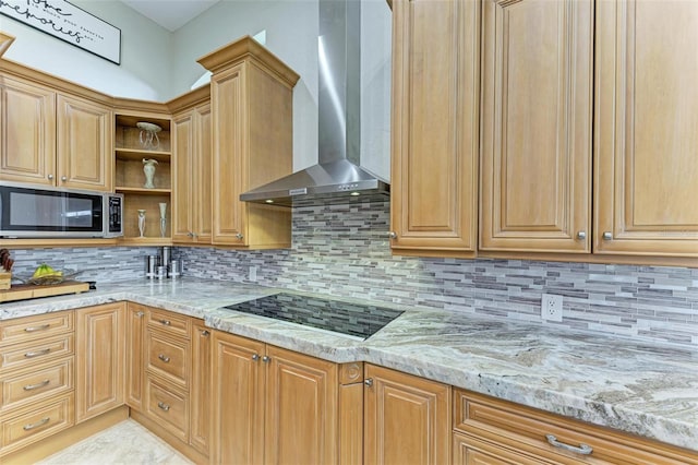 kitchen featuring black electric cooktop, decorative backsplash, light stone countertops, and wall chimney range hood