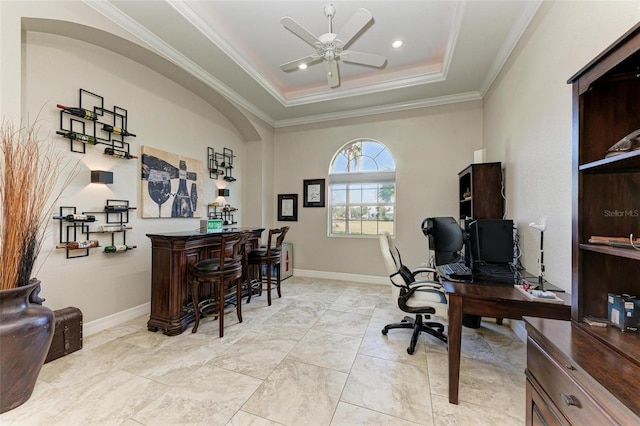 office space featuring a tray ceiling, ceiling fan, and crown molding