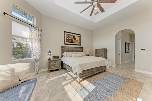 bedroom featuring a tray ceiling and ceiling fan