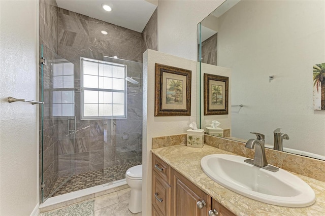 bathroom with tile patterned flooring, vanity, toilet, and an enclosed shower