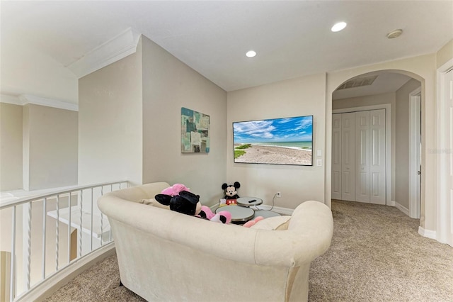 carpeted living room featuring ornamental molding