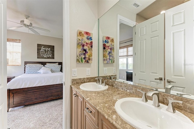 bathroom with a wealth of natural light, ceiling fan, and vanity