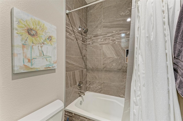 bathroom with shower / tub combo and toilet