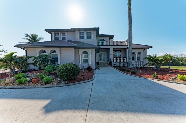 mediterranean / spanish-style house with covered porch