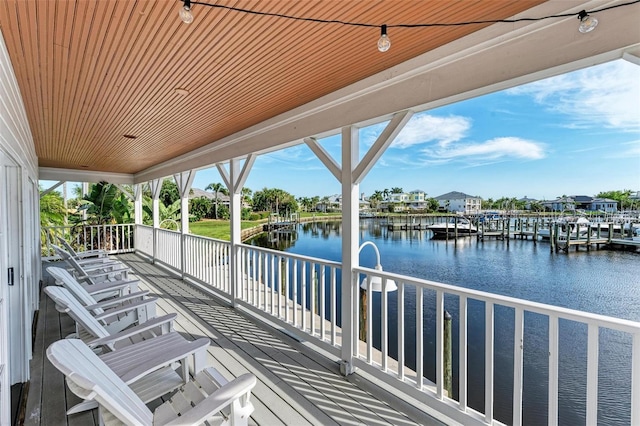 wooden terrace featuring a water view