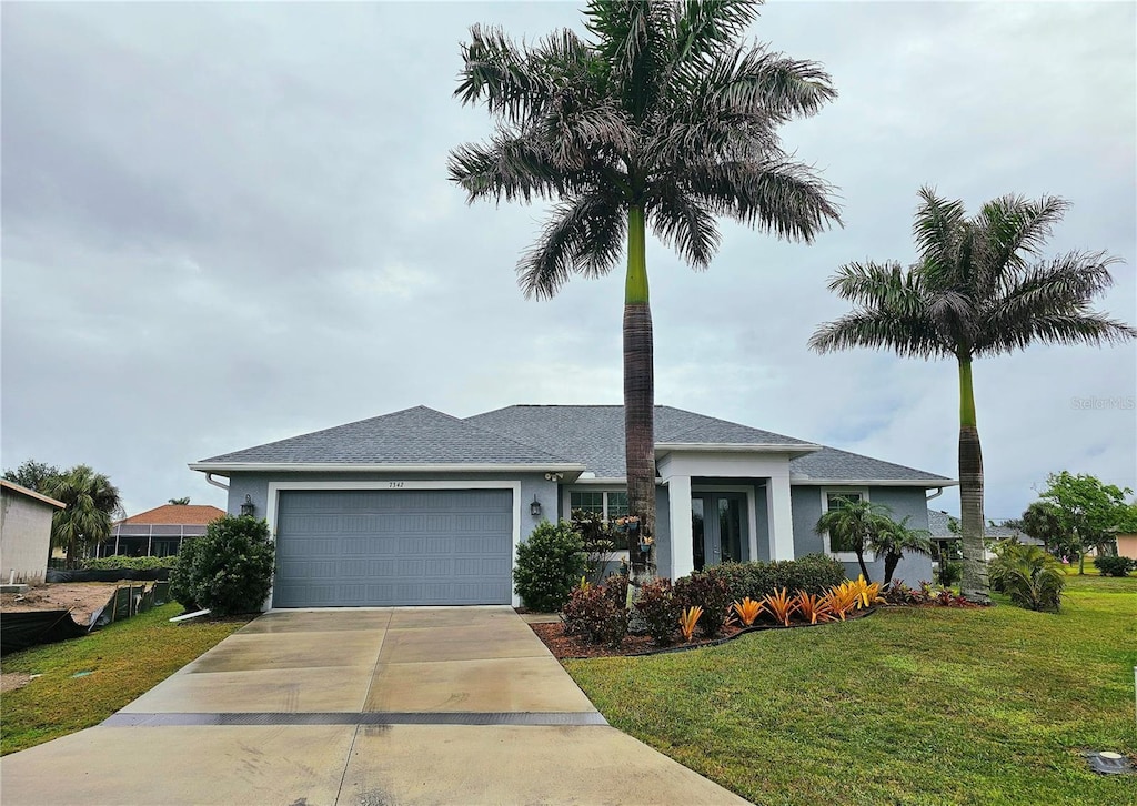 view of front of house with a front yard and a garage