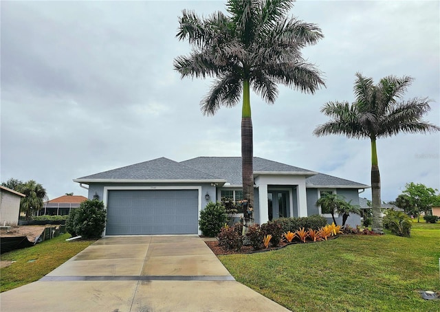 view of front of house with a front yard and a garage