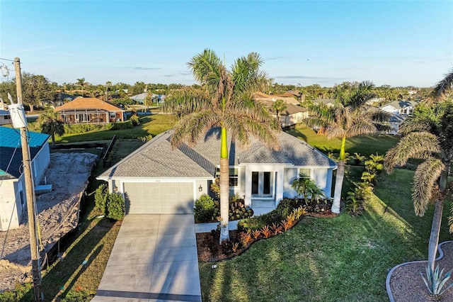 view of front of property with a garage and a front yard