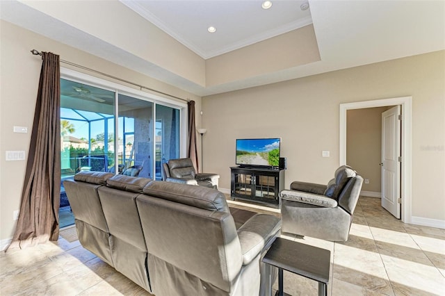 living room with a raised ceiling, crown molding, and light tile patterned floors