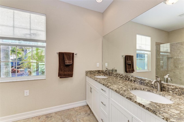 bathroom featuring plenty of natural light, an enclosed shower, and vanity