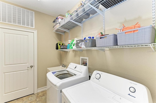 washroom featuring sink and washer and clothes dryer