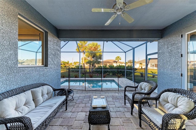 view of pool featuring a lanai, an outdoor hangout area, ceiling fan, and a patio area