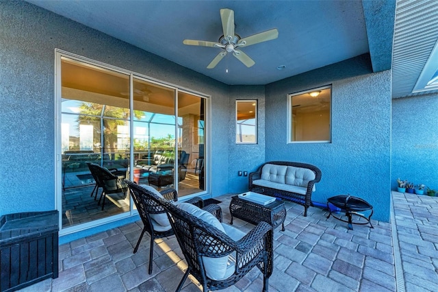 view of patio with a lanai, an outdoor hangout area, and ceiling fan