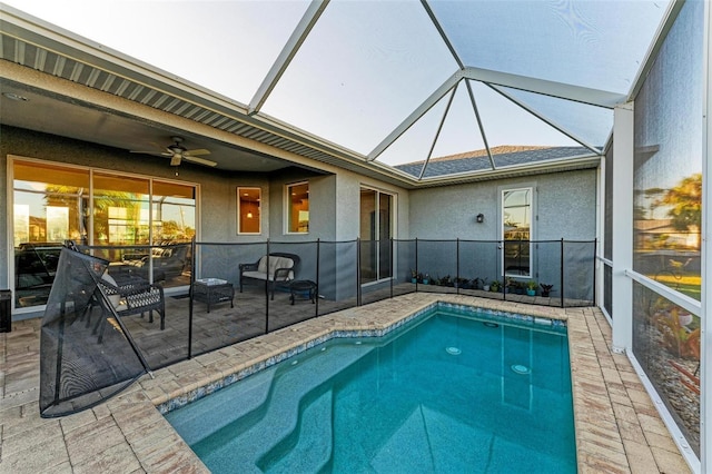 view of pool featuring a lanai, a patio area, and ceiling fan