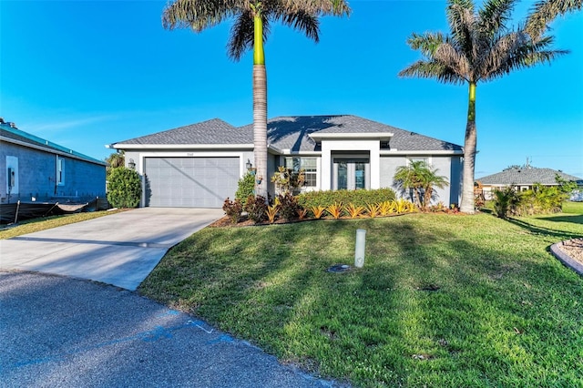 view of front of house featuring a garage and a front lawn