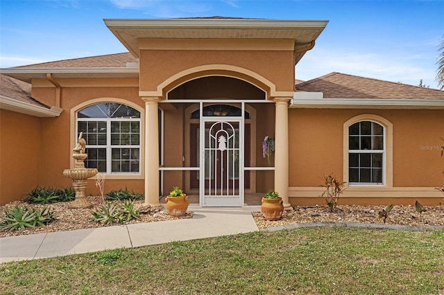 doorway to property with a yard