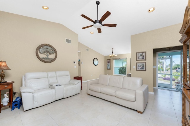 living room with ceiling fan with notable chandelier and vaulted ceiling