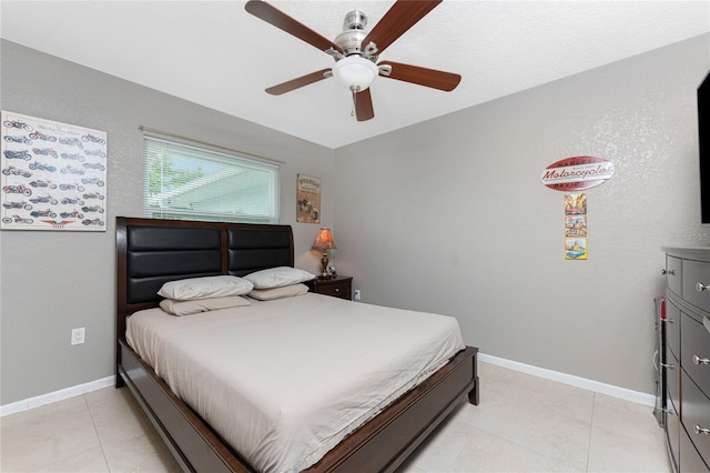 bedroom featuring light tile patterned floors and ceiling fan