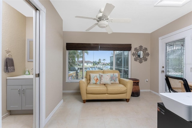 interior space with ceiling fan and light tile patterned flooring