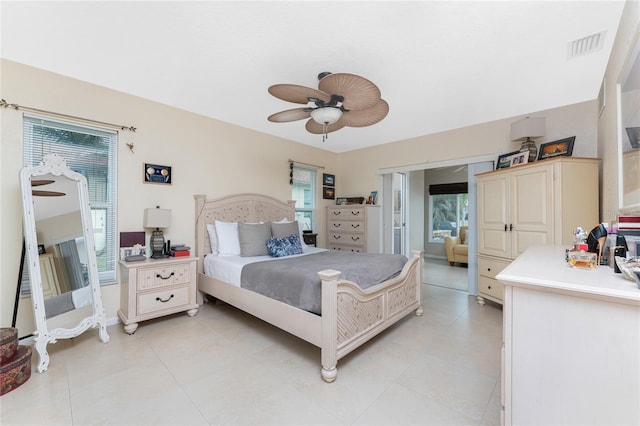 bedroom with multiple windows and ceiling fan