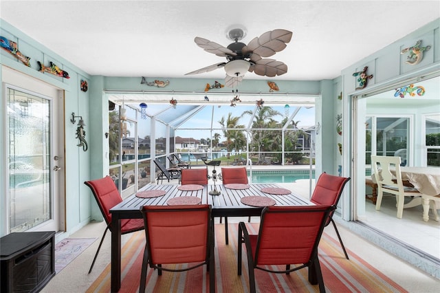 sunroom featuring ceiling fan