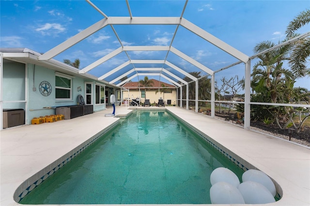 view of pool with a lanai and a patio