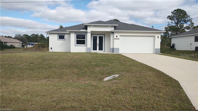 view of front facade with a garage, a front yard, and french doors