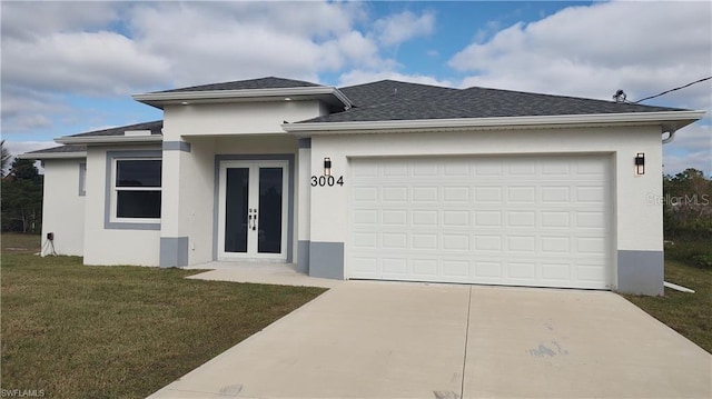 view of front facade with french doors, a garage, and a front lawn