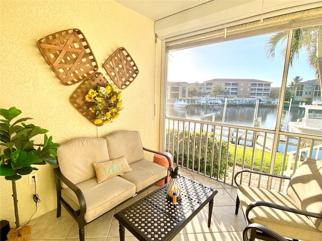 balcony with an outdoor hangout area and a water view