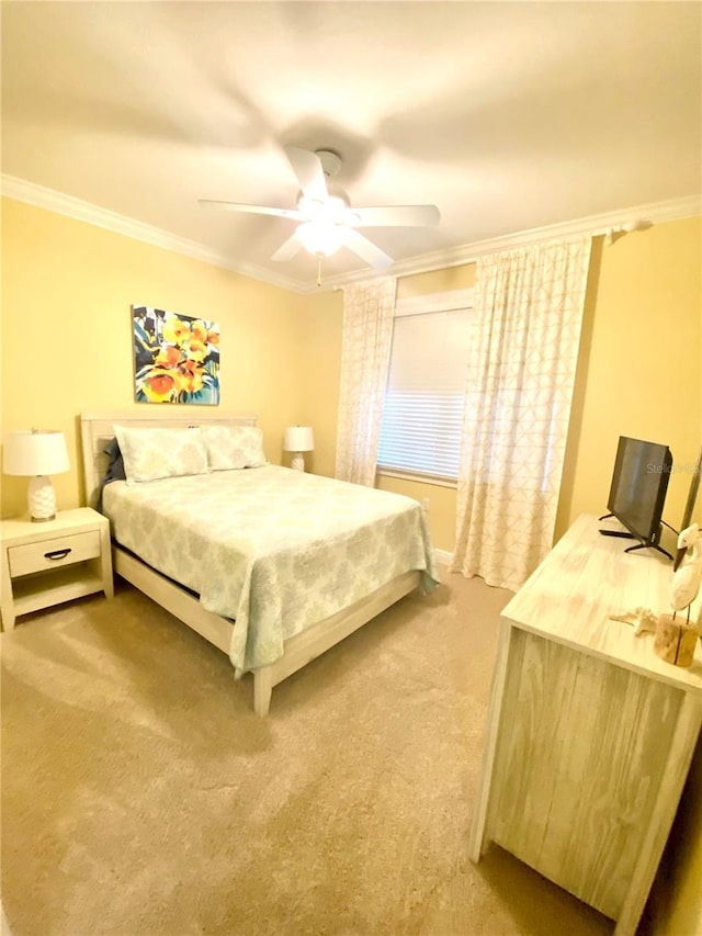 bedroom featuring crown molding, carpet floors, and ceiling fan