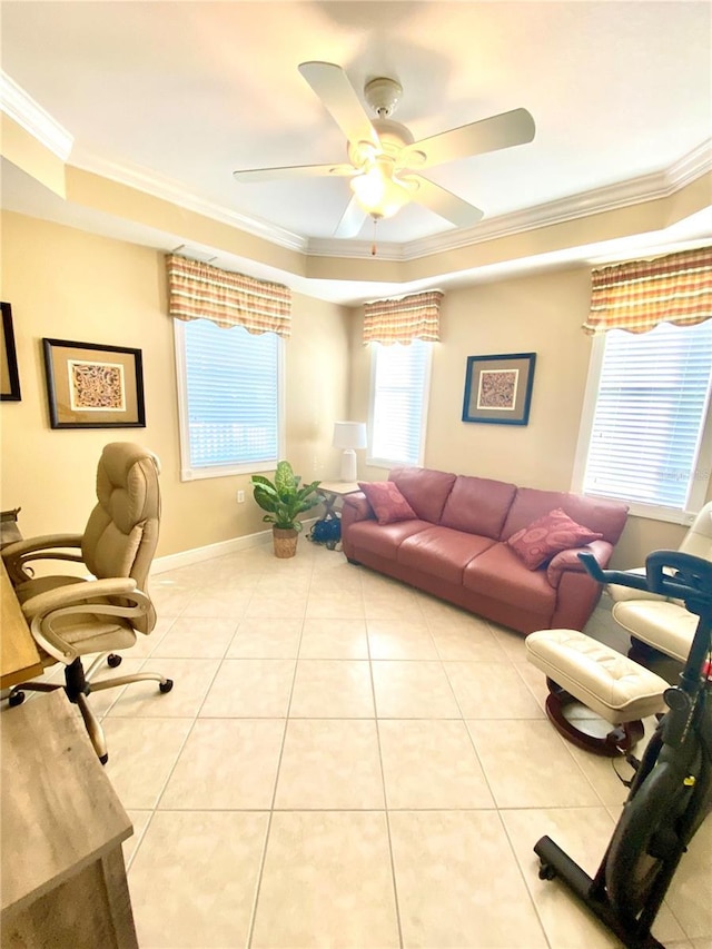 living room with a tray ceiling, a ceiling fan, tile patterned floors, and ornamental molding