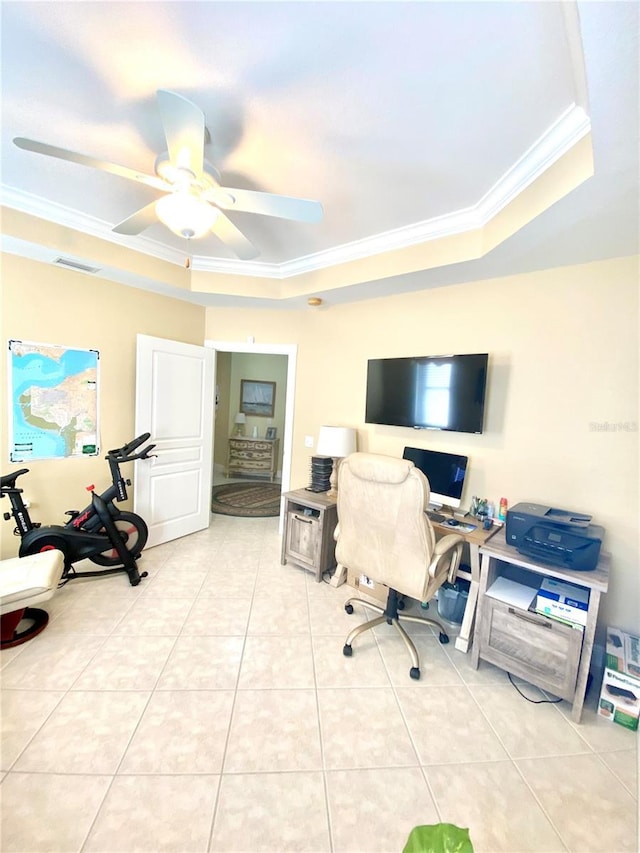 office area with light tile patterned floors, visible vents, ceiling fan, ornamental molding, and a raised ceiling