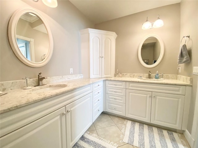 bathroom featuring double vanity, tile patterned floors, and a sink